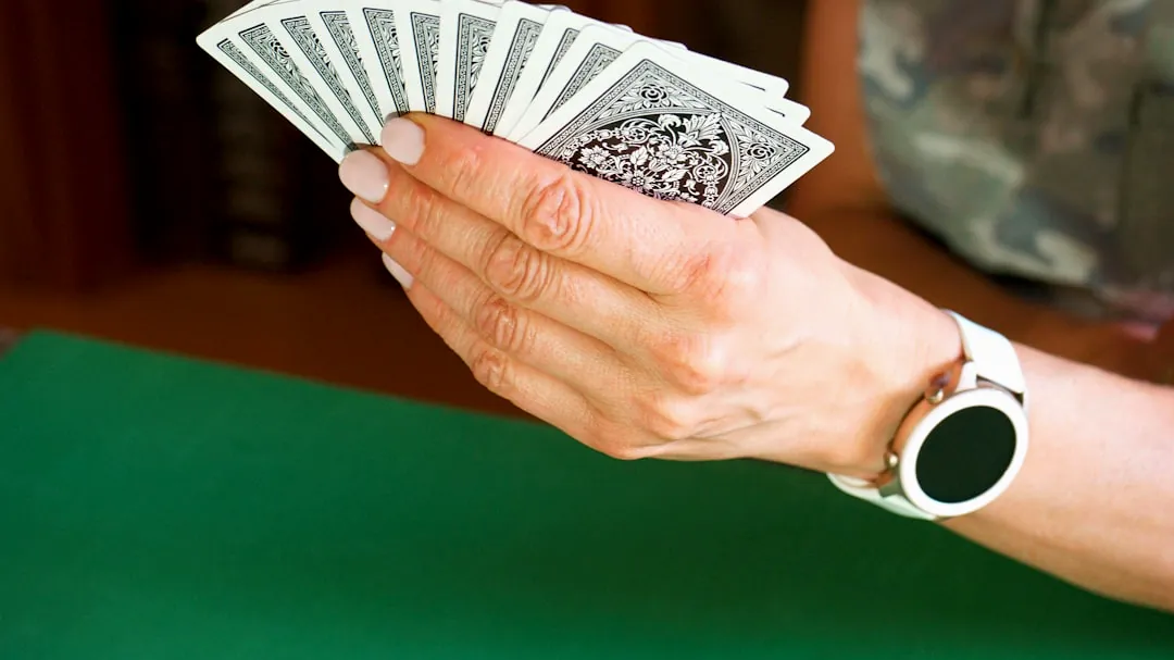 a person holding a stack of playing cards