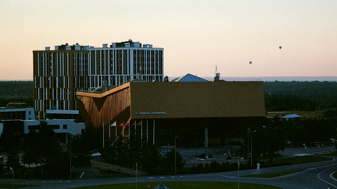 Modern buildings against a pale sky at dusk.