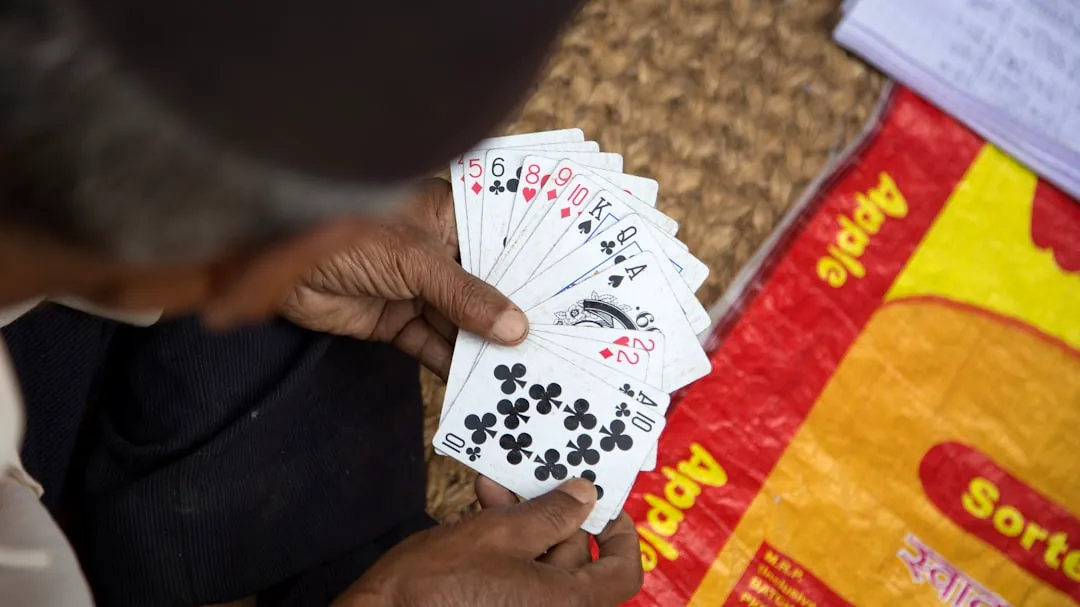 person holding playing cards