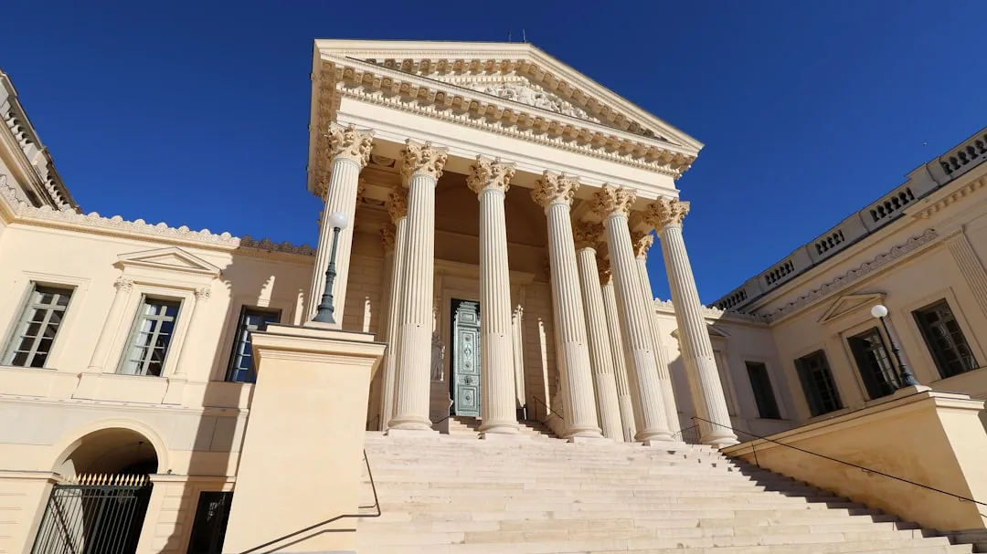 a large building with columns and a clock tower